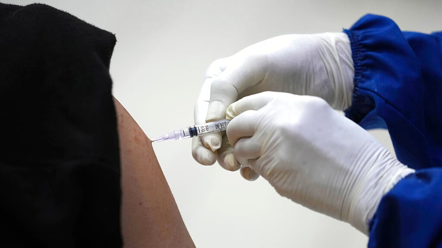 Un sanitario inyecta una dosis de AstraZeneca