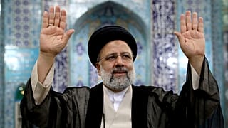 Ebrahim Raisi, a candidate in Iran's presidential elections waves to the media after casting his vote at a polling station in Tehran, Iran Friday, June 18, 2021