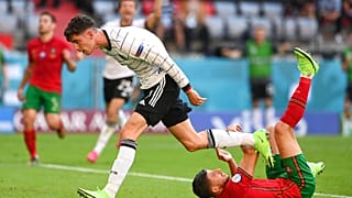 Germany's Kai Havertz and Portugal's Ruben Dias, right, after the latter scored an own goal during the Euro 2020 Group F match on Saturday