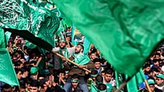 متظاهر فلسطيني يلوح بعلم حركة المقاومة الإسلامية (حماس)  