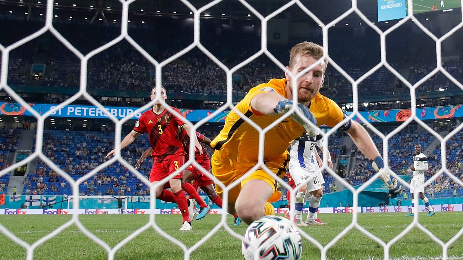 Belgium's Thomas Vermaelen, background, scores a goal as Finland's goalkeeper Lukas Hradecky fails to stop the ball in St. Petersburg, Russia, Monday, June 21, 2021