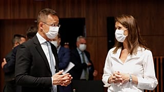 Belgium's Foreign Minister Sophie Wilmes talks to her Hungarian counterpart Peter Szijjarto.