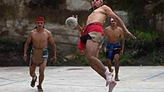 An indigenous man plays Mayan ball game