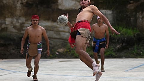 An indigenous man plays Mayan ball game