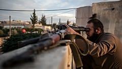 FILE: In this Thursday, Sept. 19, 2013 photo, a Syrian opposition fighter watches over as heavy fighting breaks out in in the Idlib province countryside, Syria