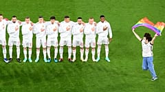 A protestor holding a Rainbow Flag runs onto the pitch in front of the Hungarian team before its Euro 2020 group F match with Germany in Munich, Germany, June 23, 2021.