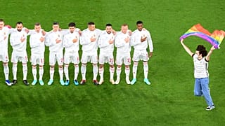 A protestor holding a Rainbow Flag runs onto the pitch in front of the Hungarian team before its Euro 2020 group F match with Germany in Munich, Germany, June 23, 2021.