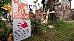 Signs are pictured at a memorial outside the Residential School in Kamloops, British Columbia., June, 13, 2021. 