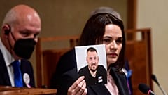 Belarusian opposition leader Sviatlana Tsikhanouskaya holds a portrait of her husband, detained in Belarus, in the Senate of the Czech Republic in Prague, June 9, 2021. 
