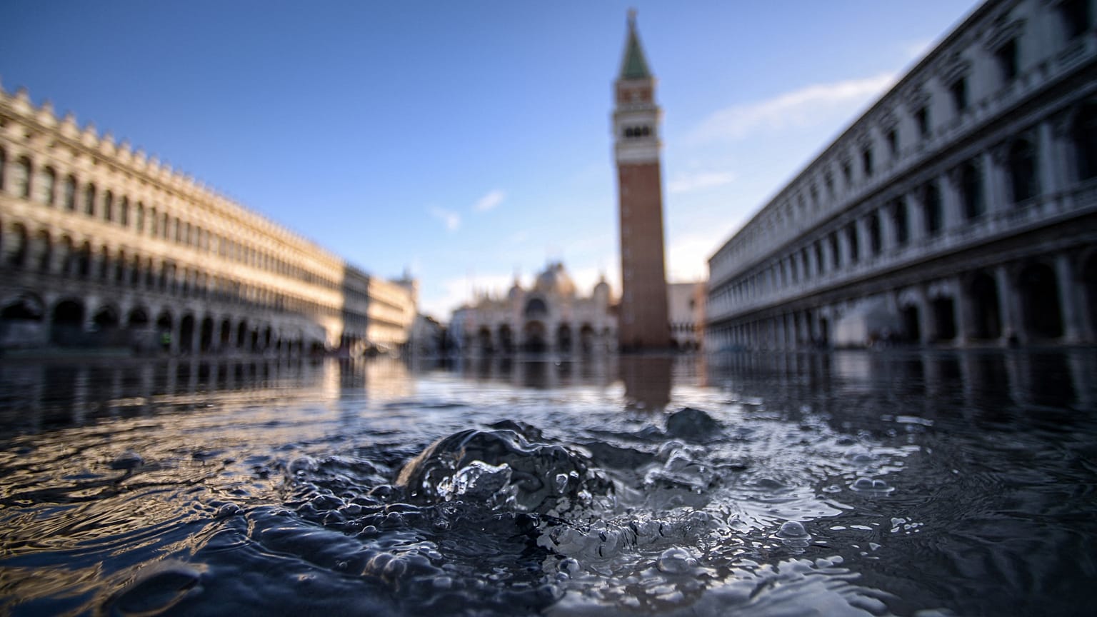 In this file photo taken on November 14, 2019 water is covering the St. Mark’s Square in Venice, Italy. 