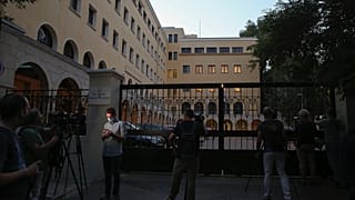 Journalists and cameramen stand outside Petraki Monastery in Athens following an attack.