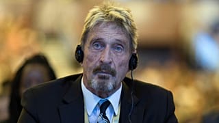 Software entrepreneur John McAfee listens during the 4th China Internet Security Conference (ISC) in Beijing in this file photo from Tuesday, Aug. 16, 2016