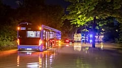 A bus is pictured stuck in water on a flooded road in Munich on Wednesday night.