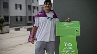 Keilan Schembre, 29, who campaigns for the YES vote during a referendum in Gibraltar, poses for a portrait next a polling station in Gibraltar, Thursday, June, 24, 2021.