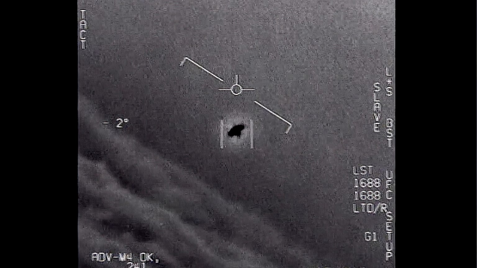 An unexplained object is seen at centre as it is tracked as it soars high along the clouds in footage provided by the US Department of Defence.