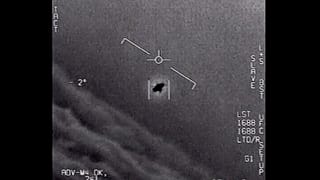 An unexplained object is seen at centre as it is tracked as it soars high along the clouds in footage provided by the US Department of Defence.