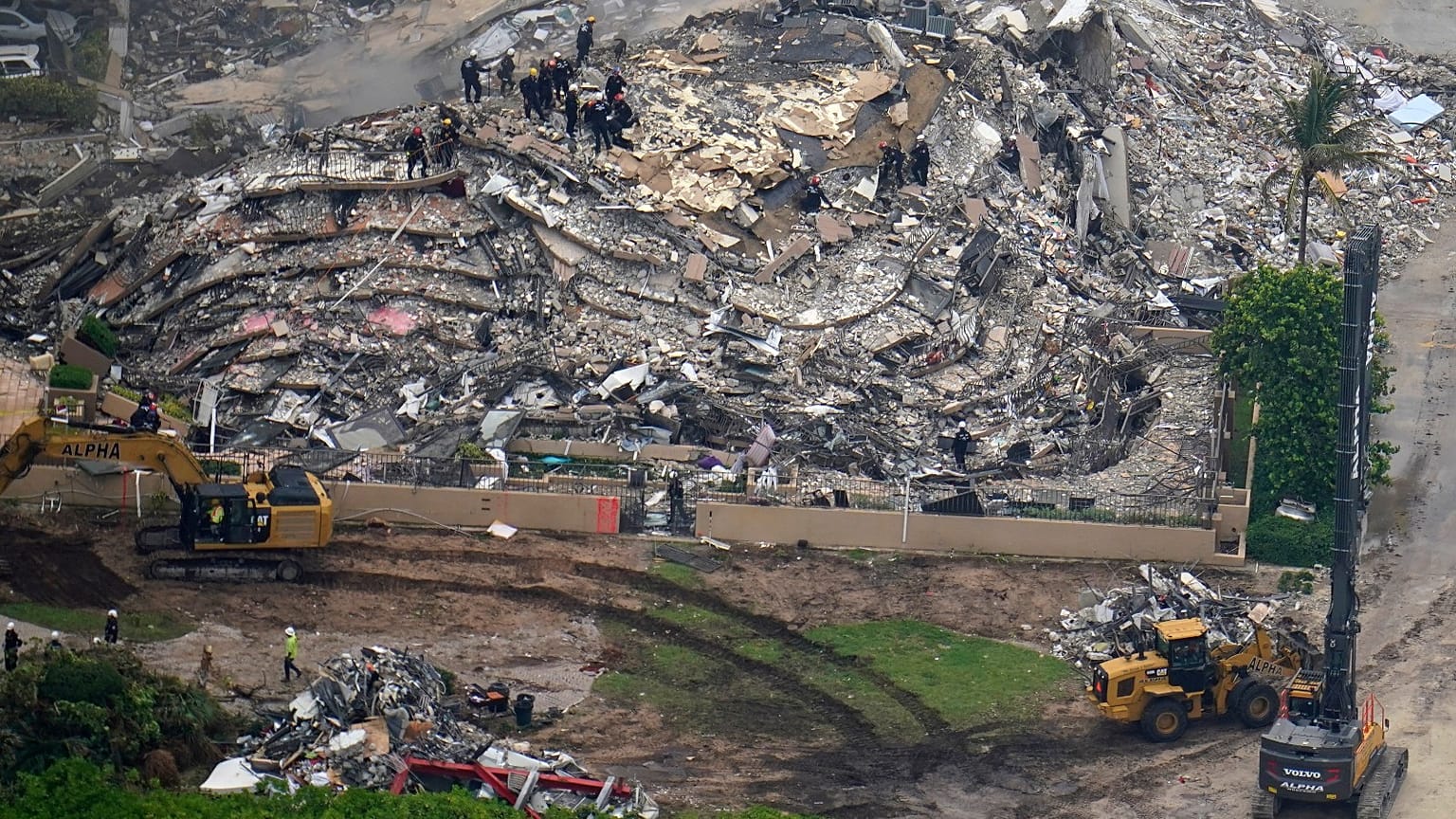 Search and rescue workers work the site of an oceanfront condo building that partially collapsed, in Surfside, Fla., Friday, 25 June 2021.