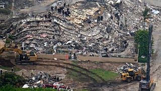 Search and rescue workers work the site of an oceanfront condo building that partially collapsed, in Surfside, Fla., Friday, 25 June 2021.