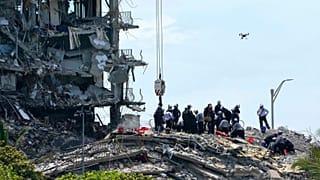 Rescue workers search in the rubble for survivors at the Champlain Towers South condominium, Saturday, June 26, 2021, in the Surfside area of Miami.