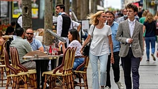 FILE: People walk at the Champs Elysees avenue in Paris, Thursday, June 17, 2021. 