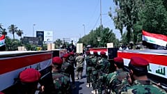الحشد الشعبي خلال جنازة رمزية في بغداد يشيع جثامين عناصره الذين قتلوا في غارة جوية أمريكية على الشريط الحدودي السوري العراقي. 2021/06/29