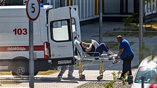 Medical workers carry a patient suspected of having coronavirus on a stretcher at a hospital in Kommunarka, outside Moscow, Russia, June 26, 2021. 