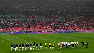 Players stand for national anthems during the Euro 2020 match between England and Scotland, at Wembley Stadium, in London, Friday, June 18, 2021.
