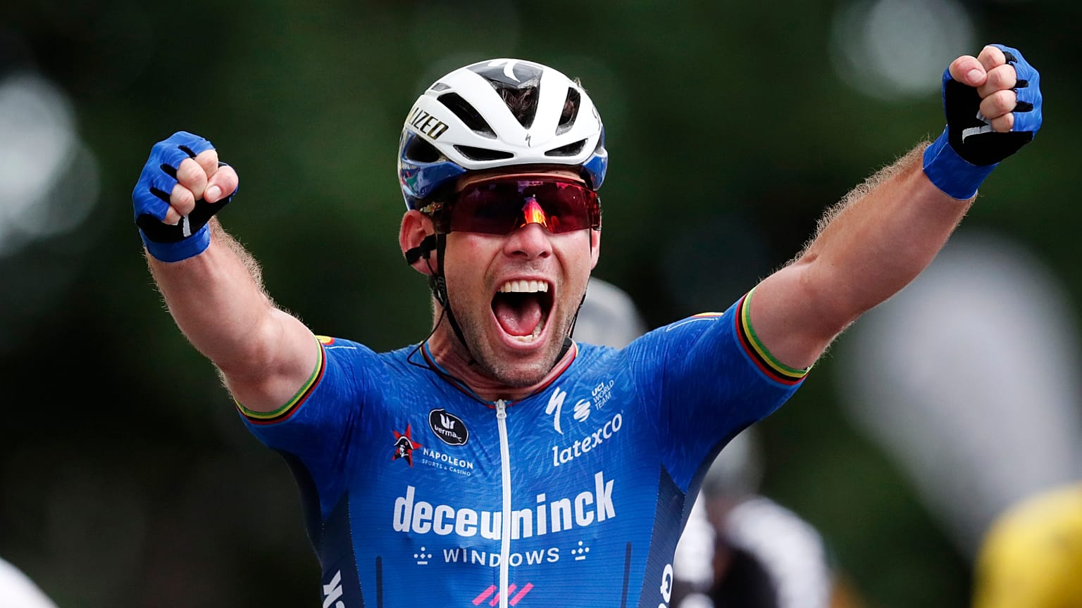 Britain's Mark Cavendish celebrates as he crosses the finish line to win the fourth stage of the Tour de France on June 29, 2021.