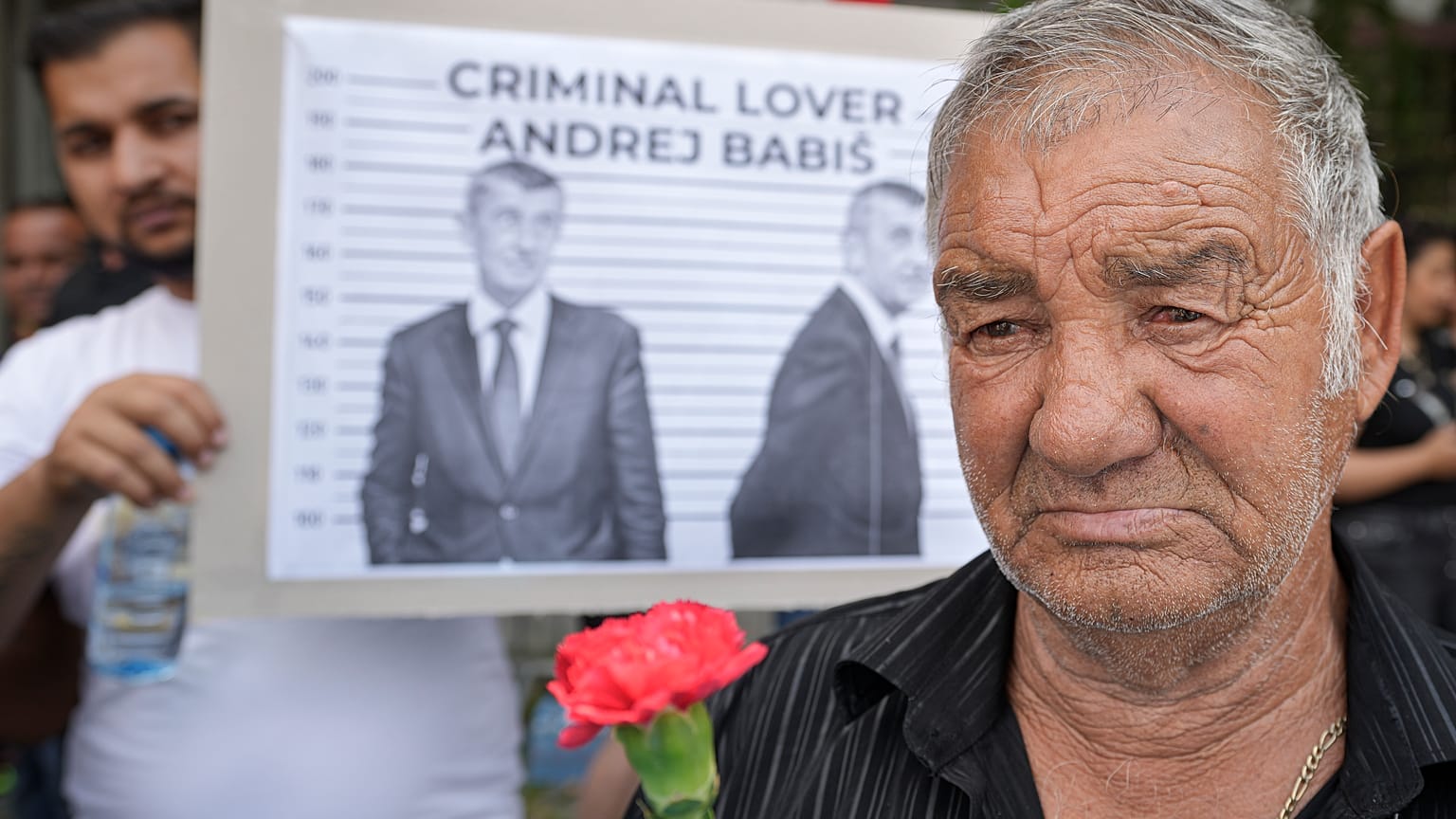 A man holds a carnation during a rally called by Roma organizations to honor a Roma man Stanislav Tomas who died after police officers held him in the Czech Republic.