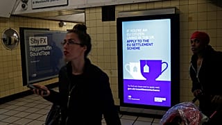 A poster encourages EU nationals to apply to the Government's post-Brexit EU settlement scheme at South Kensington underground station in London on March 25, 2019.