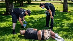 With the temperature well over 100 degrees, officials from a special fire unit check on the welfare of a man in Mission Park in Spokane, Wash., Tuesday, June 29, 2021.