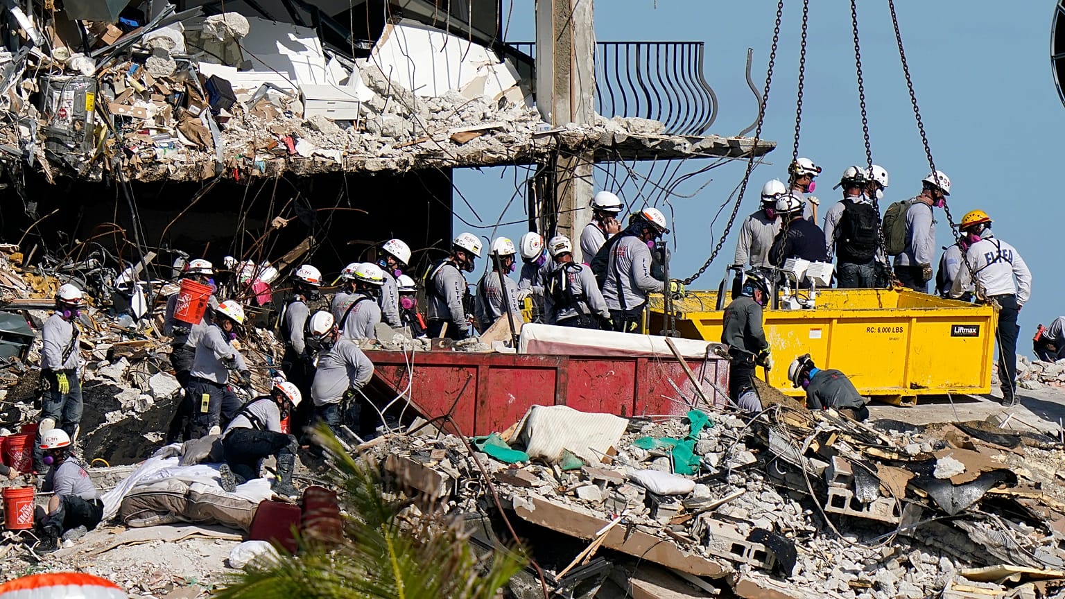 workers search the rubble at the Champlain Towers South Condo in Surfside, Fla. on June 28, 2021.