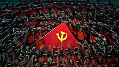 Performers gather around a Communist Party flag during a gala ahead of the 100th anniversary of the founding of the Chinese Communist Party in Beijing on June 28, 2021.