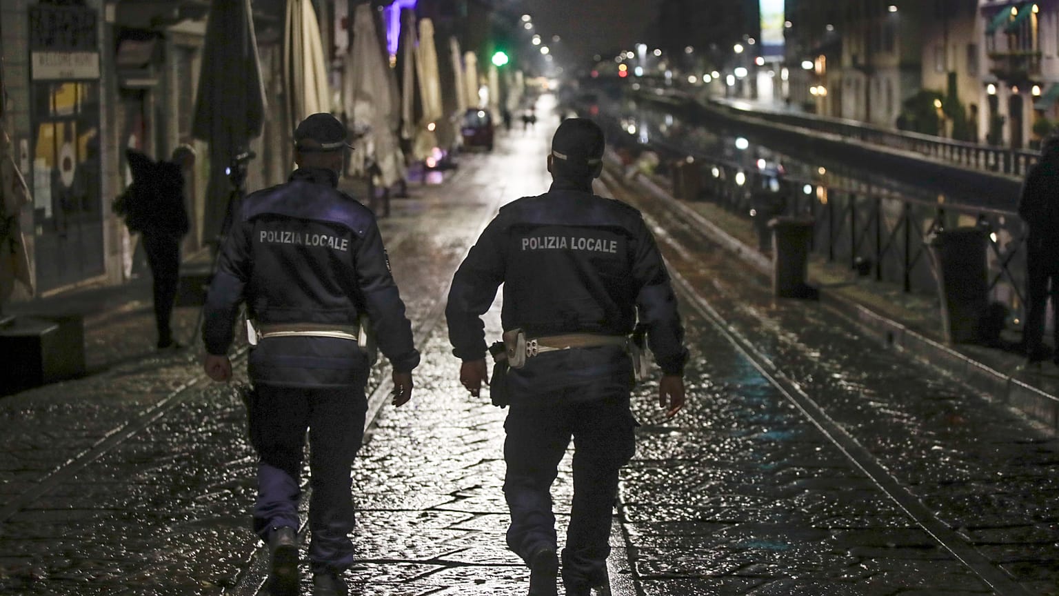 Two city police officers patrol the Navigli area of Milan.