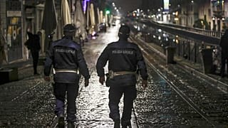 Two city police officers patrol the Navigli area of Milan.