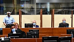 Jovica Stanisic, centre, and his subordinate Franko "Frenki" Simatovic, right, appear in court at the UN International Residual Mechanism for Criminal Tribunals.