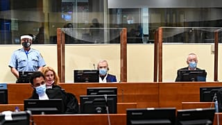 Jovica Stanisic, centre, and his subordinate Franko "Frenki" Simatovic, right, appear in court at the UN International Residual Mechanism for Criminal Tribunals.