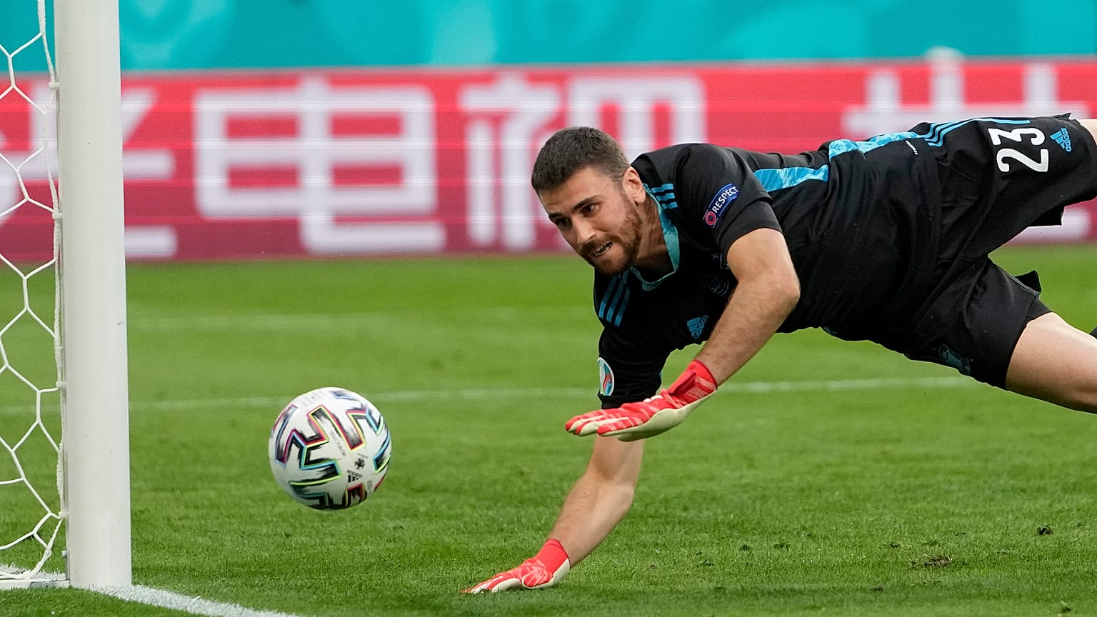 Spain's goalkeeper Unai Simon dives for a save during the Euro 2020 championship quarterfinal match between Switzerland and Spain in Saint Petersburg.