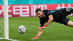 Spain's goalkeeper Unai Simon dives for a save during the Euro 2020 championship quarterfinal match between Switzerland and Spain in Saint Petersburg.