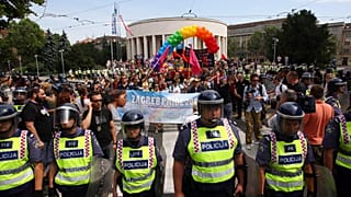 Police protect participants as they take part in the Gay Pride march in Zagreb, Croatia, Saturday, June 18, 2011.