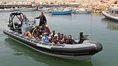 Migrants rescued by Tunisia's national guard from the Mediterranean arrive at the port of el-Ketef near the Libyan border, June 27, 2021. 