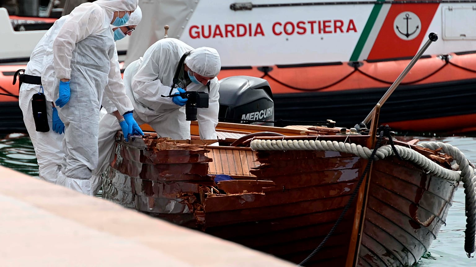 Italian forensic police inspect the damage on the couple's boat.