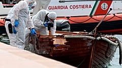 Italian forensic police inspect the damage on the couple's boat.