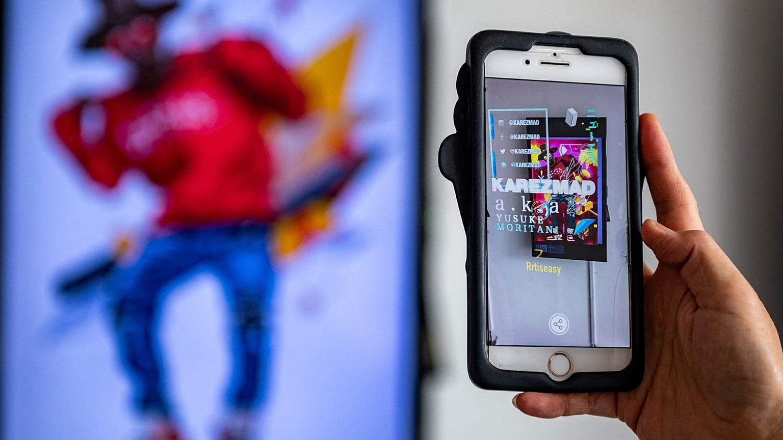  A visitor looks at artist Yasumasa Yonehara's "Sup" with a mobile phone app, during "CrypTOKYO", a physical blockchain art exhibition in Tokyo.