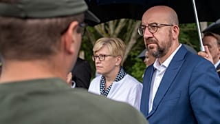 European Council President Charles Michel and Lithuania's Prime Minister Ingrida Simonyte speak with members of the Lithuania State Border Guard on Tuesday.