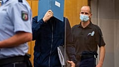 The main defendant hid his face as he arrives for sentencing at the court in Münster.