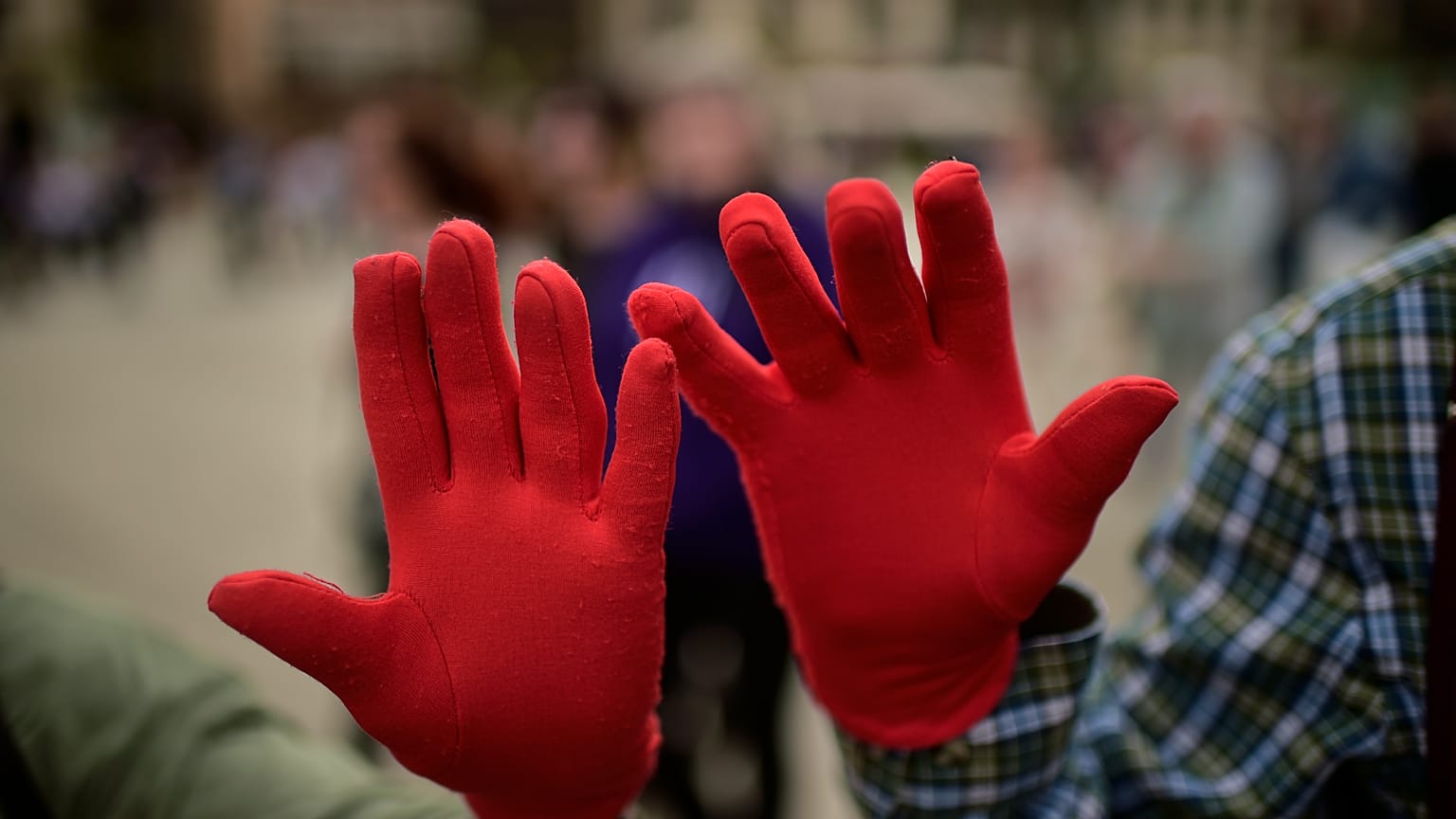 Protestors wearing red gloves take part in a protest against male sexual violence in Pamplona in 2018.