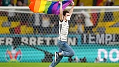 A fan with a LGBT pride flag runs on the pitch during the national anthems before the Euro 2020 soccer championship group F match between Germany and Hungary.