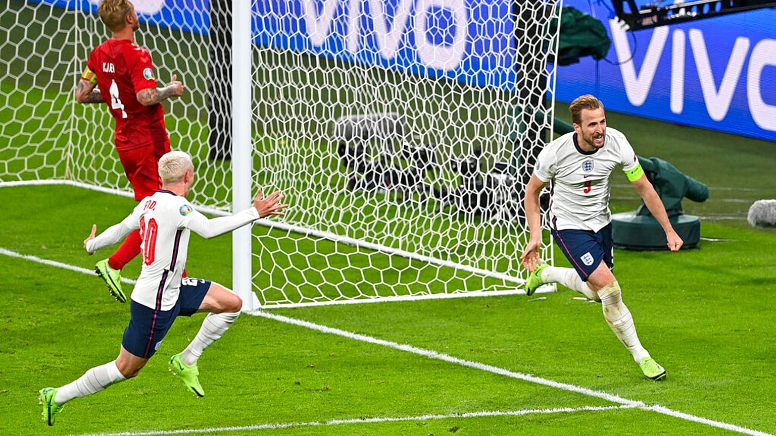 England's Harry Kane, right, reacts after scoring his team's second goal during the Euro 2020 soccer championship semifinal between England and Denmark at Wembley stadium.
