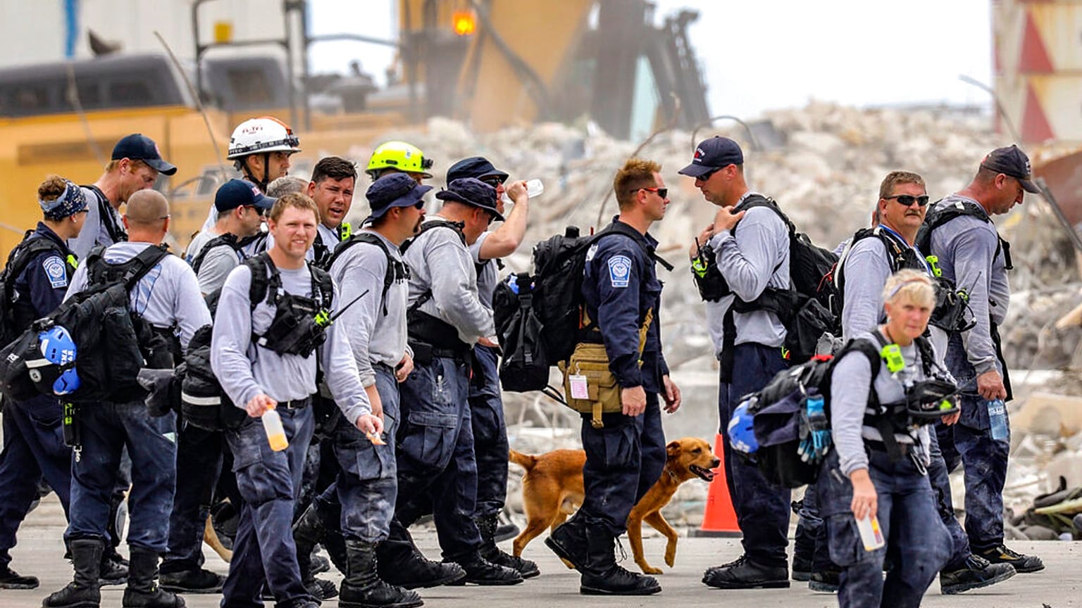Search and rescue team members depart after working the debris field of the Champlain Towers South